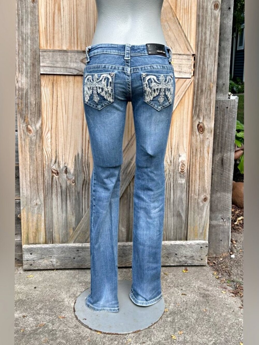 Grace in LA Stretch Denim Cross with Wings Low Rise Embellished Boot Cut Jeans